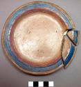 Pottery plate- buff with pink, blue and gold