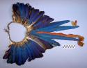 Headdress of blue feathers with orange feathers in center