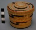 Twined spruce root basket (A) with knobbed lid (B)