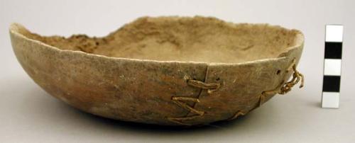 Gourd bowl containing beans and a peanut