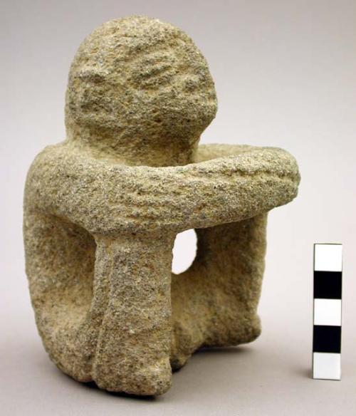 Carved groundstone "Sukia" figure, seated male