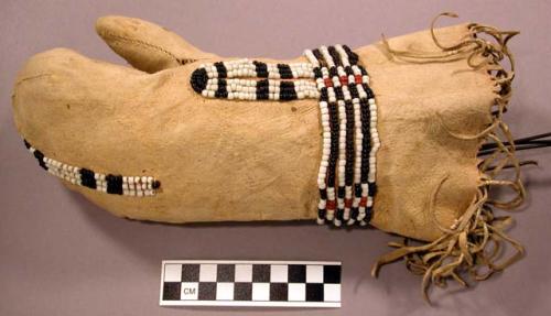 Mitten, buckskin (?), fringed, beaded decoration, sewn w/ sinew