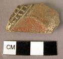 One small polychrome body sherd with incised checkered design