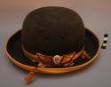 Bowler hat. dark brown felt with gold satin weave strip and cord tassel. two air