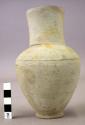 Bottle, pottery, closed inside of neck except for slits through the pottery seal