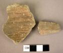 2 potsherds - slipped and burnished, probably cognates or prototypes of "flat bo