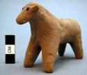 Unfired clay figurine depicting cow
