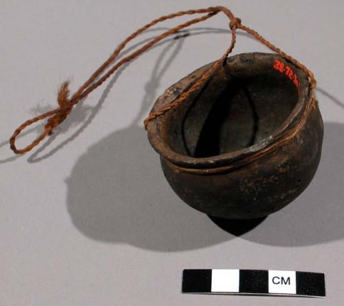 Miniature pottery vessel with bast fibre cord around the neck