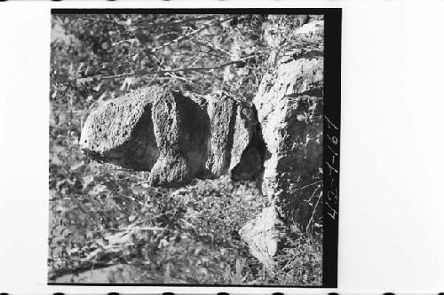 Side view of carved figure with front completely burned off