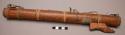 Flute, of wood with leather thongs tied around it and decorative appendage