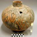 Ceramic jar, straight neck, black on orange exterior, mended, sherds missing