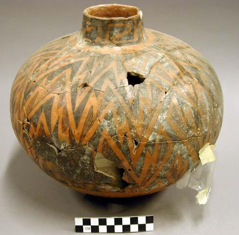 Ceramic jar, straight neck, black on orange exterior, mended, sherds missing