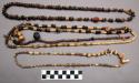 Necklace of chancala seeds and bird bones with various pendants