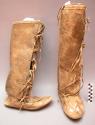 Woman's boots, possibly Omaha. Rawhide soles. Bison hide uppers, quillwork