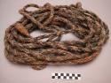 Rope. Braided leather loop through which horsehair rope passes.