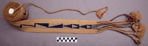 Woven wool belt, white ground. blue design. donor says: "old in 1928". 8 x 270