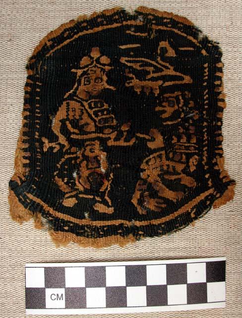 Textile fragment.  Wool fibre.  Human figure design.  4 3/4" long, 4 1/2" wide.