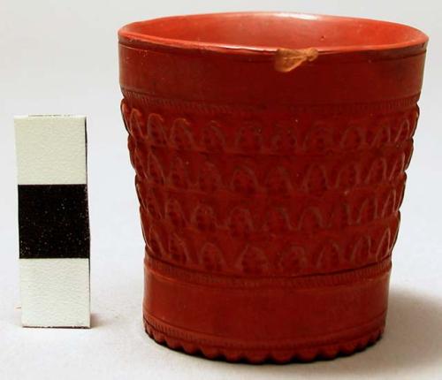 Miniature red pottery vase with incised design