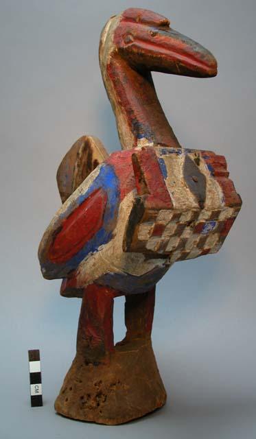 Ritual wooden bird figure, with shield form on cheek