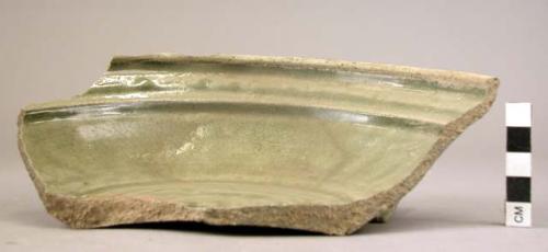 Ceramic partial dish, dark green glaze on int., plain ext., ring base