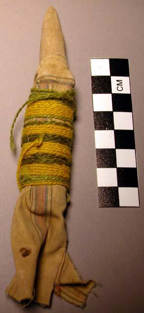 Child's doll - clay wrapped with cloth and green and yellow string +