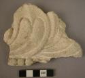 Plaster fragment with floral design, 6" wide, from wall of lamasery