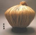 Raffia covered pottery resonator, used with horn or vocally