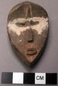 Miniature devil mask or a personally owned symbol representing devil bust.