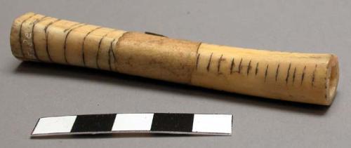 Paper bag containing 8 smoking pipes: (a-e) 5 of bone, all with incised black li