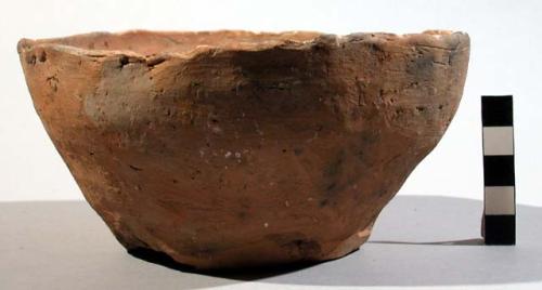 Clay eating pot, round, uneven with a few clumps on rim and on bottom. native na