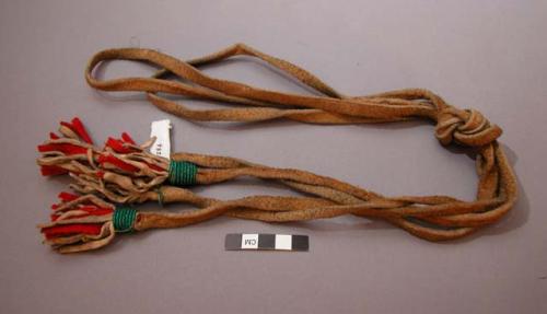 2 leather ties, possibly Plains. Leather and flannel tassles wrapped w/ beads.