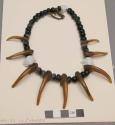 Boy's necklace of 38 blue beads and 9 claws (?) on rawhide thong