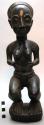Baule crouching female figure, wood with black paint