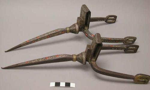 Metal spurs with inlaid and applied brass and silver designs