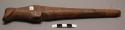 Carved wooden flute, 3 perforations, tapered at one end.
