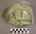 Ceramic partial bowl, green w. dark green floral design, glazed, ring base