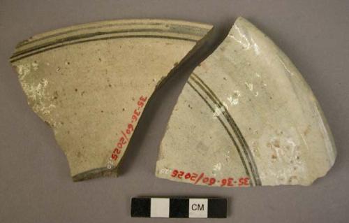 Ceramic bowl rim sherds, white with blue painted linear design, glazed