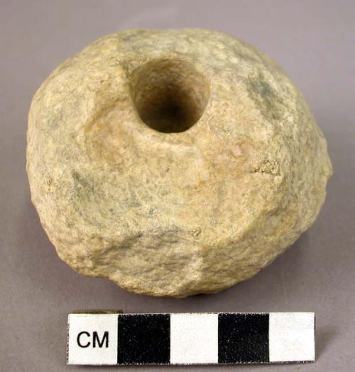 White circular stone 2" diameter (mill stone?) - hole and groove in it