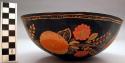 Gourd shell bowl, painted black; carved and painted on the outside