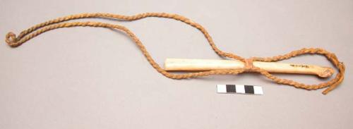 Crow eagle bone whistle. Incised zigzag design, twisted leather thong, pigment