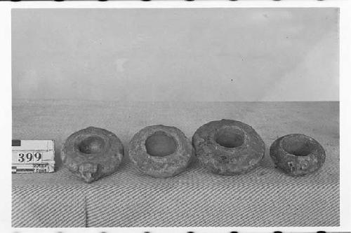 Four Small Polished Stone Vessels with Flat Bases