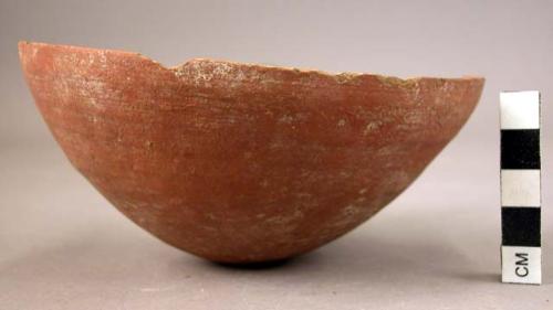 Ceramic partial bowl, red ware, round base, splayed sides, cracked