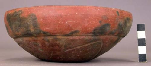 Red bowl with designs on underside