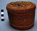 Twined spruce root basket (A) with handled lid (B)
