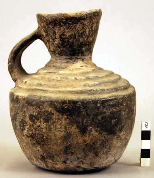 Pottery jar, handle on side, black, grooved ornament