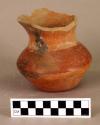 Shouldered pottery jar with flaring rim and red painted decoration