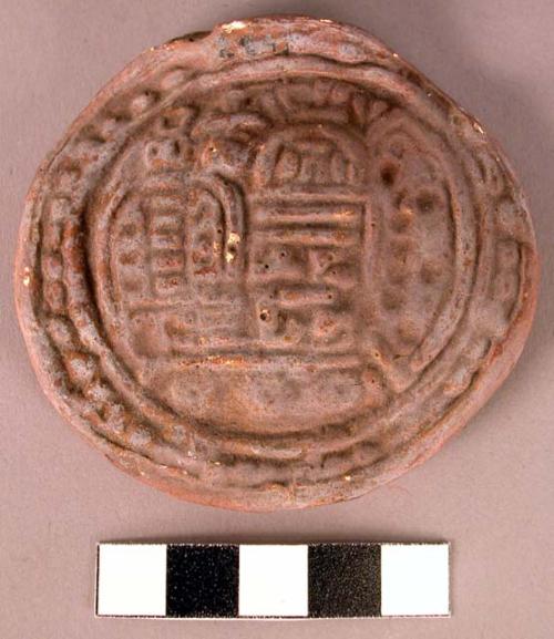 CAST, moulded and incised disk