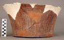 Fragment of truncated conical vase - red ware; flat bottom; incised geometric design