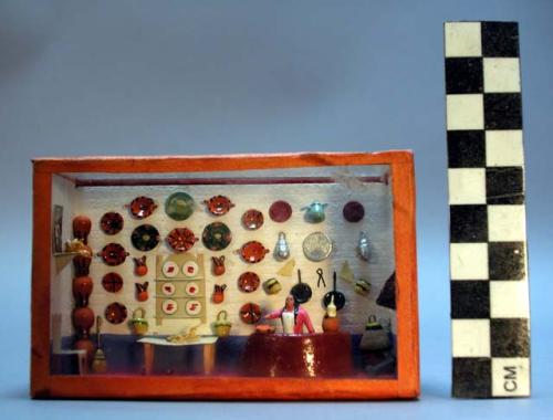 Ceramic polychrome miniture kitchen scene in glass + wooden box.