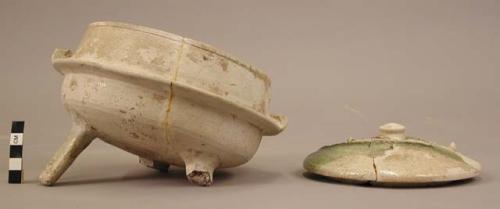 Pottery bowl - grey ware; traces of green glaze; 3 legs; handles at sides; cover with thick incrustation of green glaze